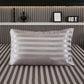 Hand resting on the smooth satin pillowcase to show the glide