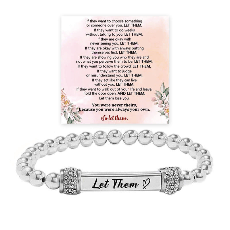 Silver bead stainless steel bracelet with an engraved bar and wing accents
