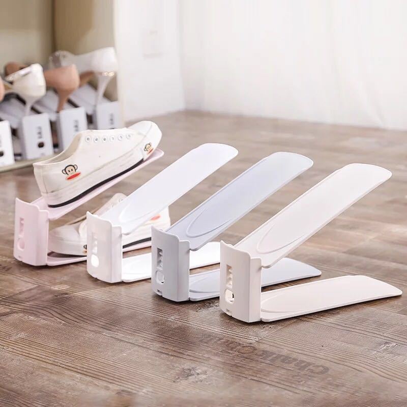 Double layer shoe organizers in several colors lined up on a shelf