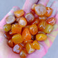 Assorted dyed agate tumbled stones showing natural banding and colour