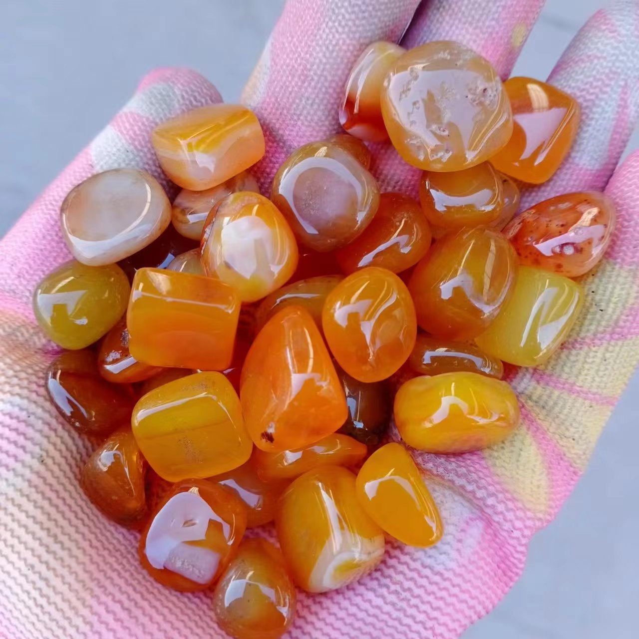 Assorted dyed agate tumbled stones showing natural banding and colour