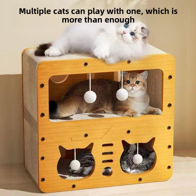 Two cats resting on and inside a double layer cardboard cat scratcher house with cat face cutouts and balls