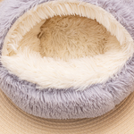 Close view of the cream plush interior of a grey semi-enclosed round pet nest