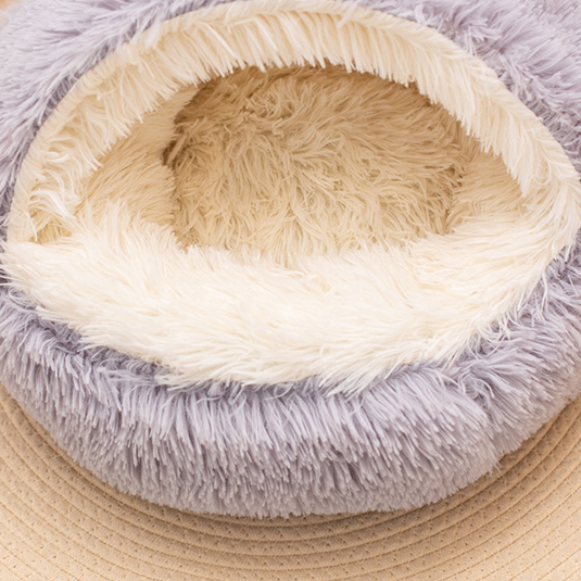 Close view of the cream plush interior of a grey semi-enclosed round pet nest