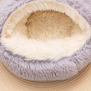 Close view of the cream plush interior of a grey semi-enclosed round pet nest