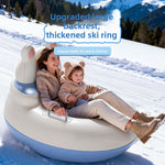 Mother and child sitting together in an inflatable snow ring with a raised backrest sliding down a snowy slope