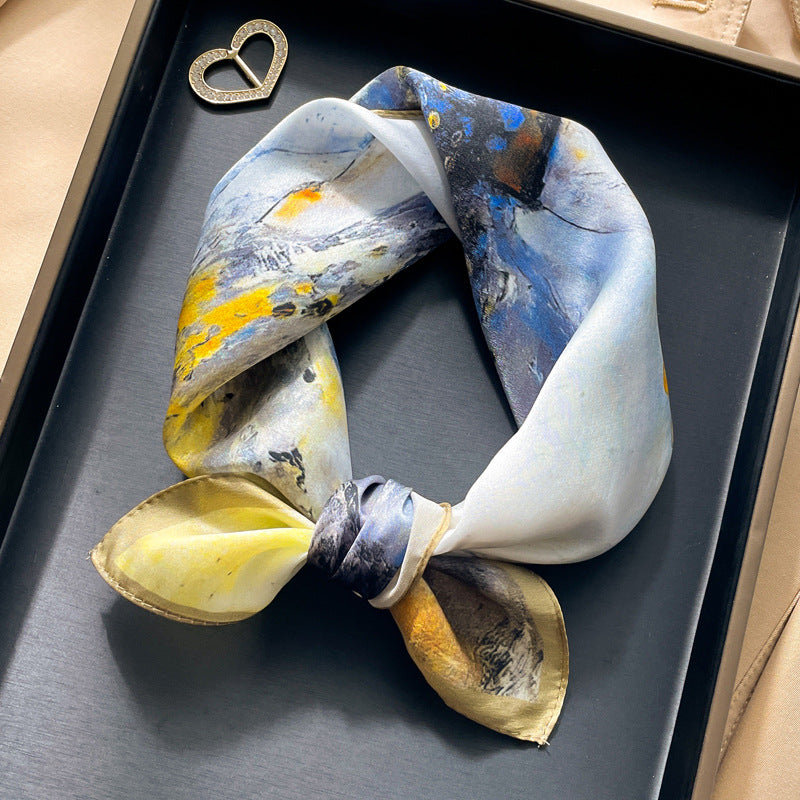 Yellow and blue floral printed square scarf with a satin sheen and hemmed edges, shown displayed