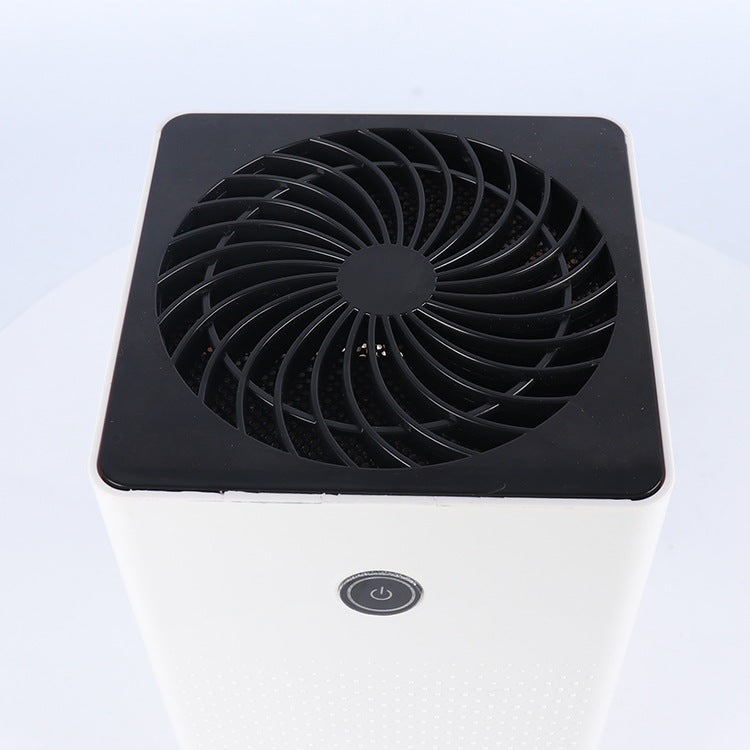 Top view of the dehumidifier black fan grille and touch power button on the white body