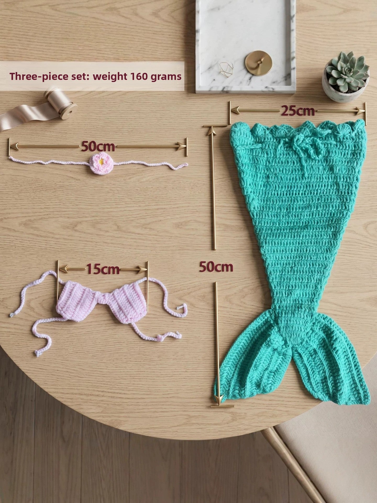 Three piece mermaid set laid out with size marks, tail 25 by 50 cm, headband 50 cm and top 15 cm
