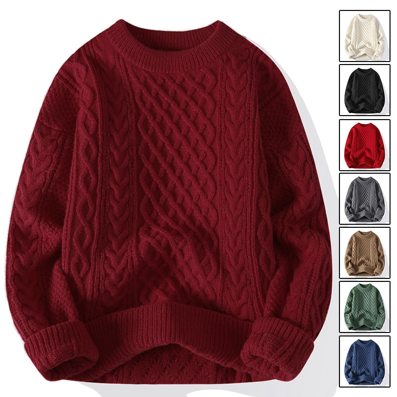 Cable knit crewneck pullover laid flat showing raised braided cable panels and a ribbed round neck