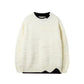 White whale jacquard knit sweater with black inner collar and wavy hem, flat view, size L option