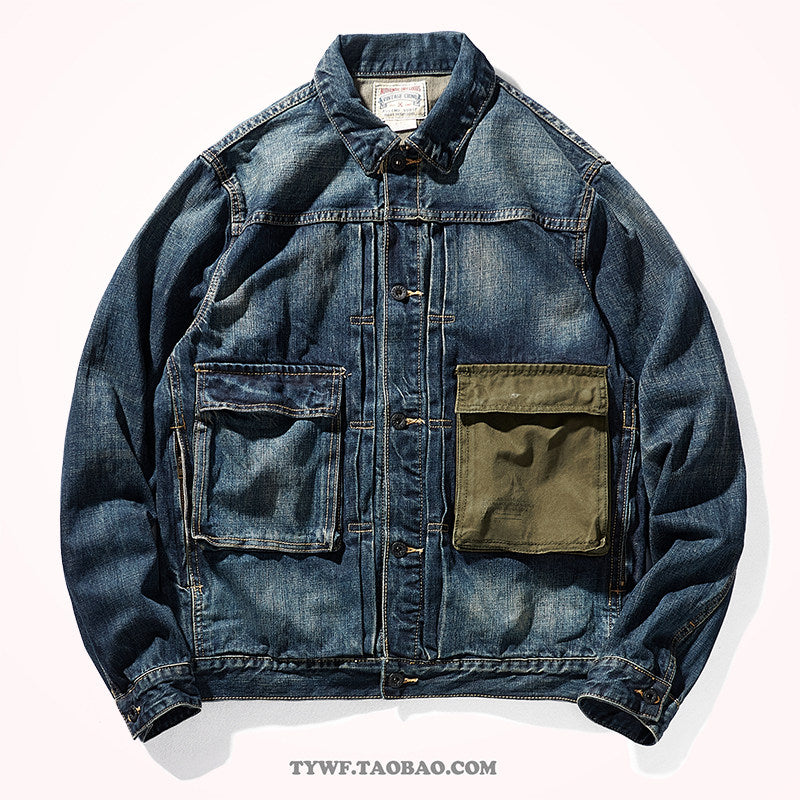 Faded blue denim work jacket front with olive canvas chest pocket and copper buttons