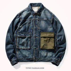 Faded blue denim work jacket front with olive canvas chest pocket and copper buttons