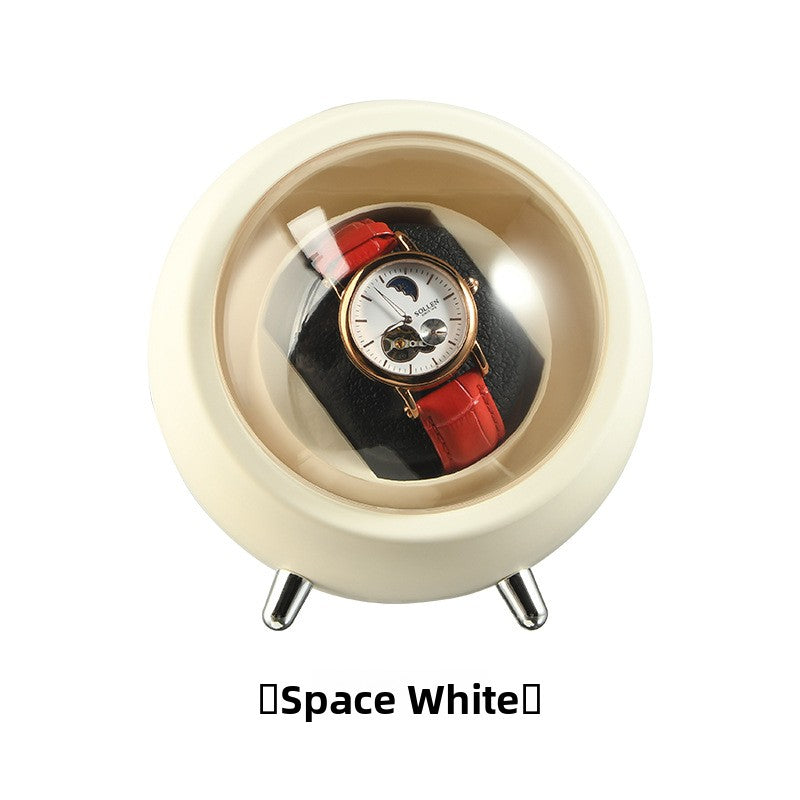 Space White watch winder capsule showing the cushion holder and clear dome over a wristwatch