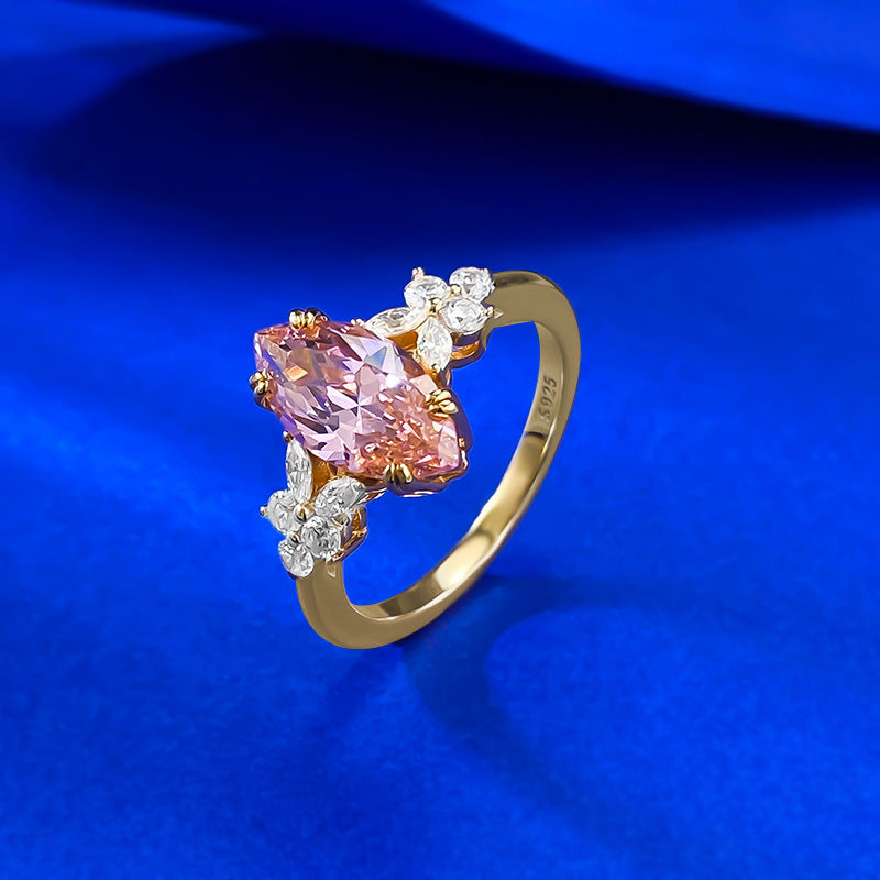 Angled view of the gold toned band showing the S925 stamp inside the shank, pink marquise stone