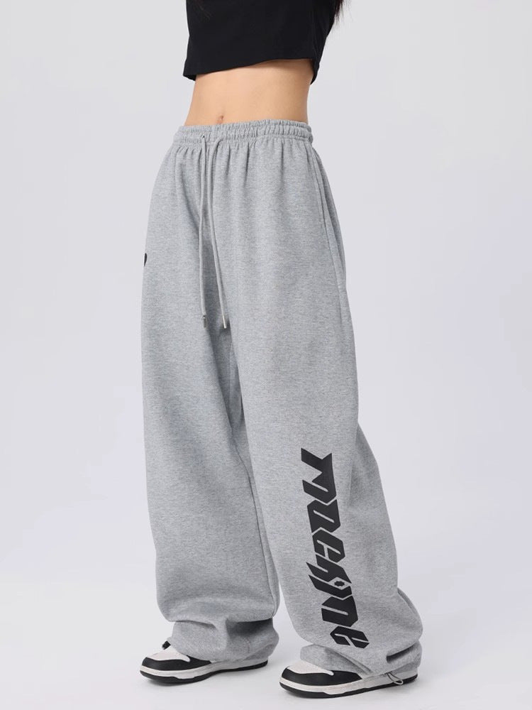 Womens grey wide leg hip hop dance pants with a drawstring waist, front view on a model