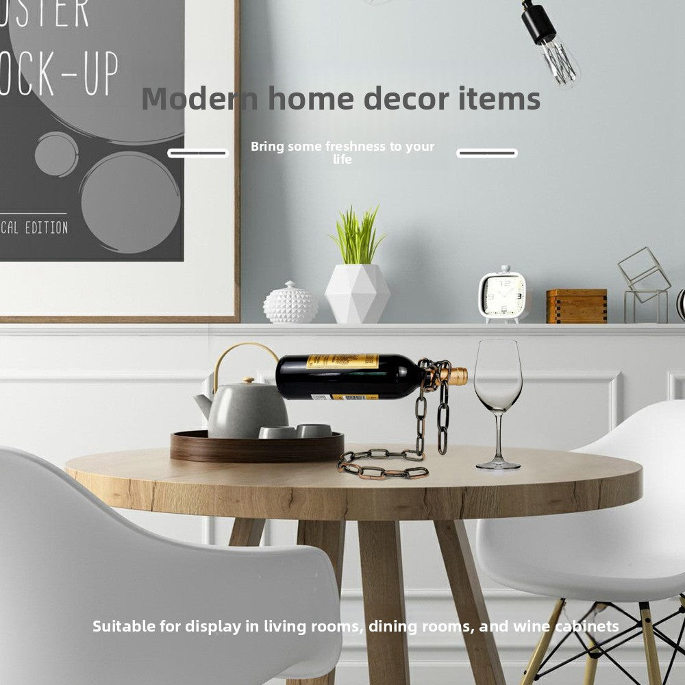 Iron chain wine bottle holder with a bottle on a round dining table in a grey room, modern home decor text