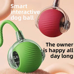 Green and red silicone rolling pet balls with clear hubs and braided rope tails on a peach backdrop
