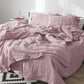 Muted solid color cotton linen bedding set, duvet cover, sheet and pillowcases on a bed