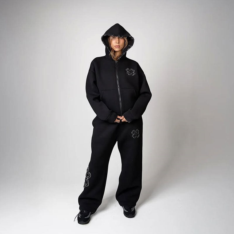 Black option photo of a woman in a black zip hoodie with hood up and wide leg trousers, size XXXXL