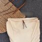 Woven straw tote carried on the shoulder during a sunny market walk