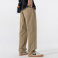 Khaki straight leg cotton pants in size XXL, side view with a hand in the pocket and low sneakers