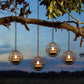 Solar candle ball lantern styled on an outdoor patio table