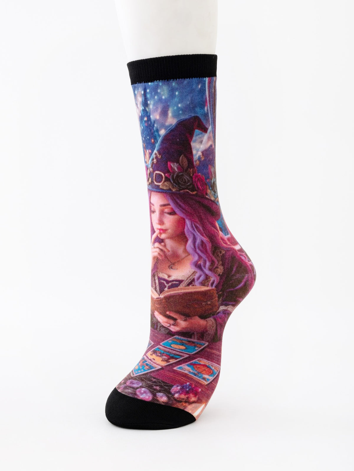 Mid-calf sock on a mannequin printed with a witch with long purple hair reading beside tarot cards