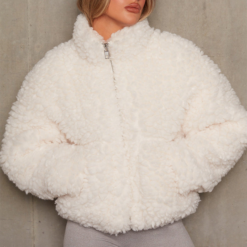 Black curly teddy fleece jacket zipped up over grey leggings