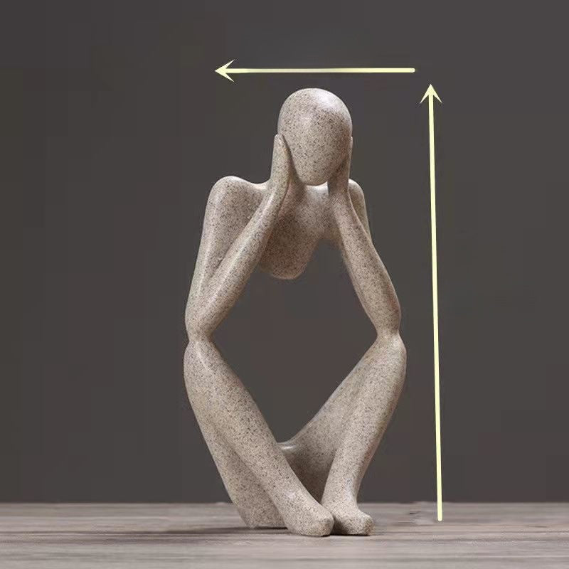 Sandstone finish abstract resin meditator figurine with height arrows on a dark backdrop