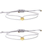 Two light gray cord bracelets with small gold tone charms and adjustable slide knots