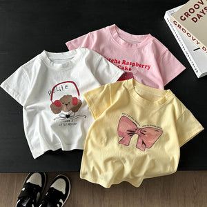 Group of children's cotton t-shirts in white, pink and yellow with a puppy, pink lettering and a bow print