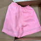 Pink linen shorts back view showing patch pocket and deep turned-up leg hem