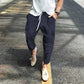 Navy blue ribbed corduroy pants with drawstring waist and thigh pockets, photo used for the Navy Blue S option