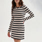 Black and cream striped ribbed knit mini dress with long sleeves and a round neck on a model