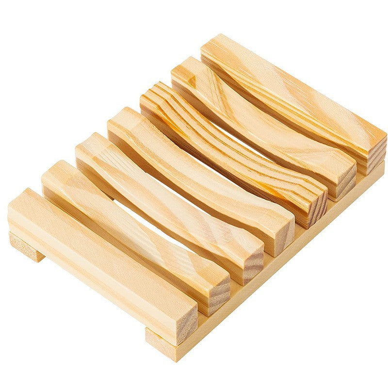 Natural pine wood slatted soap rack with pale grain and side rails on a white background