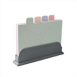 Set of four PP cutting boards in pink green purple and tan with food icon tabs