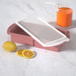Flexible platinum silicone ice cube tray held flexed to pop out cubes for frozen broth and baby food