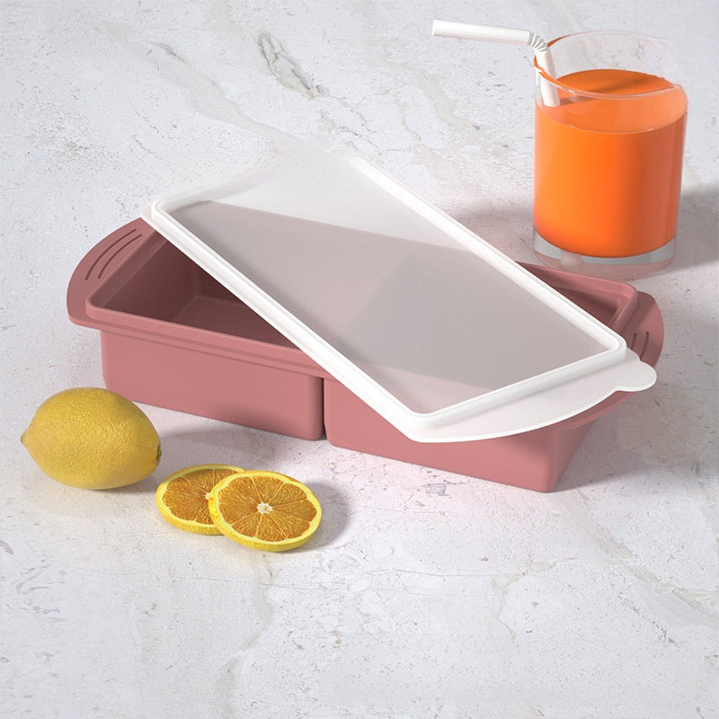 Flexible platinum silicone ice cube tray held flexed to pop out cubes for frozen broth and baby food