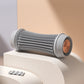 Foot massage roller next to a hand to show its compact floor roller scale