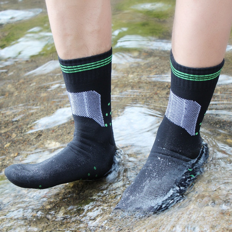Waterproof black crew socks with green stripes and a gray mesh panel worn in shallow water, size S 37-39