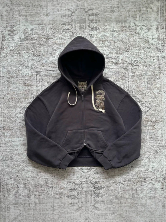 Black washed zip-up hooded sweatshirt with an embroidered animal on the chest and a wolf face inside the hood
