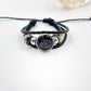 Pink braided cord bracelet with a sun charm and sliding knot closure