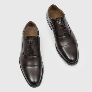 Top down view of brown mens oxford shoes, five eyelet lacing, stitched toe cap and tan lining