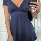 Navy deep V-neck babydoll top with eyelet lace trim shown close up on a model