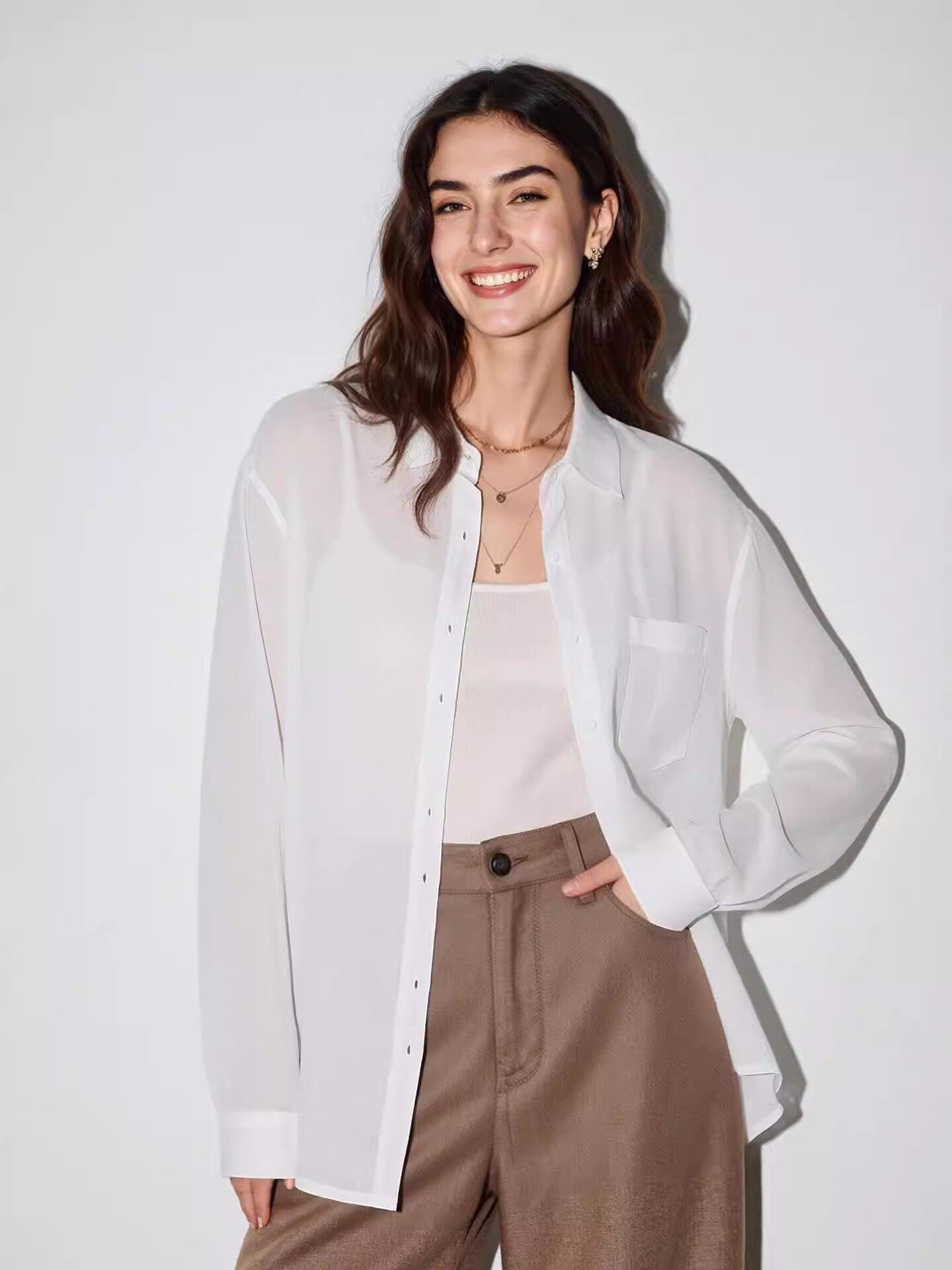 Back view of a lightweight linen blend button-up shirt with long sleeves and dropped shoulders