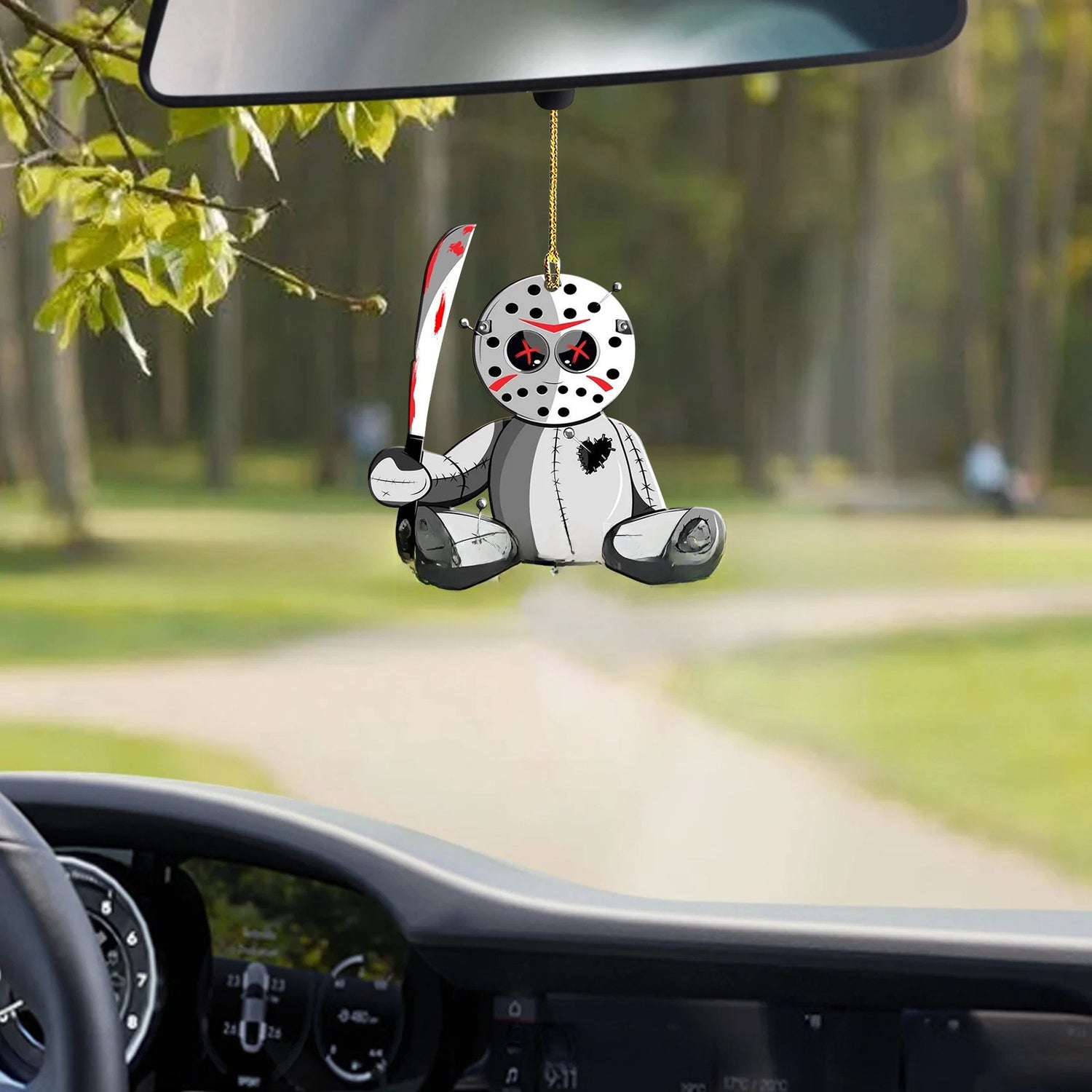 Spooky doll in a white dress acrylic hanging ornament on a decorated Christmas tree