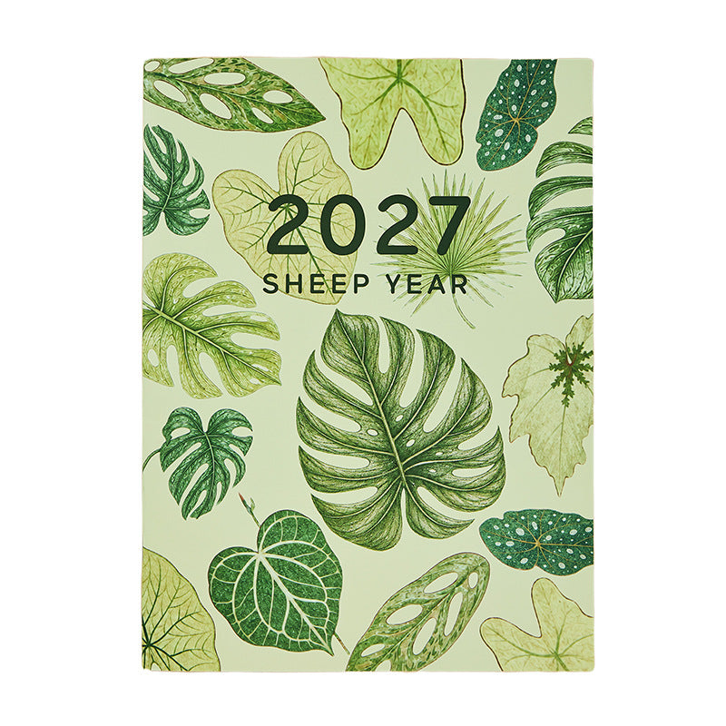 Monthly planner notebook shown open with a monthly grid and lined pages