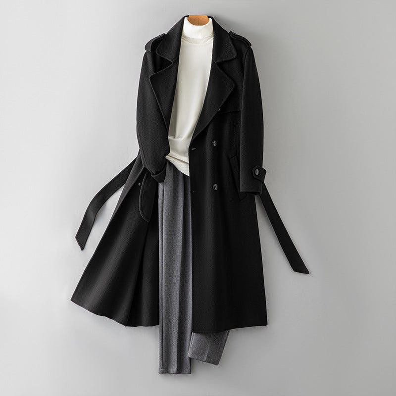 Black double breasted double faced wool overcoat with belt shown on a hanger