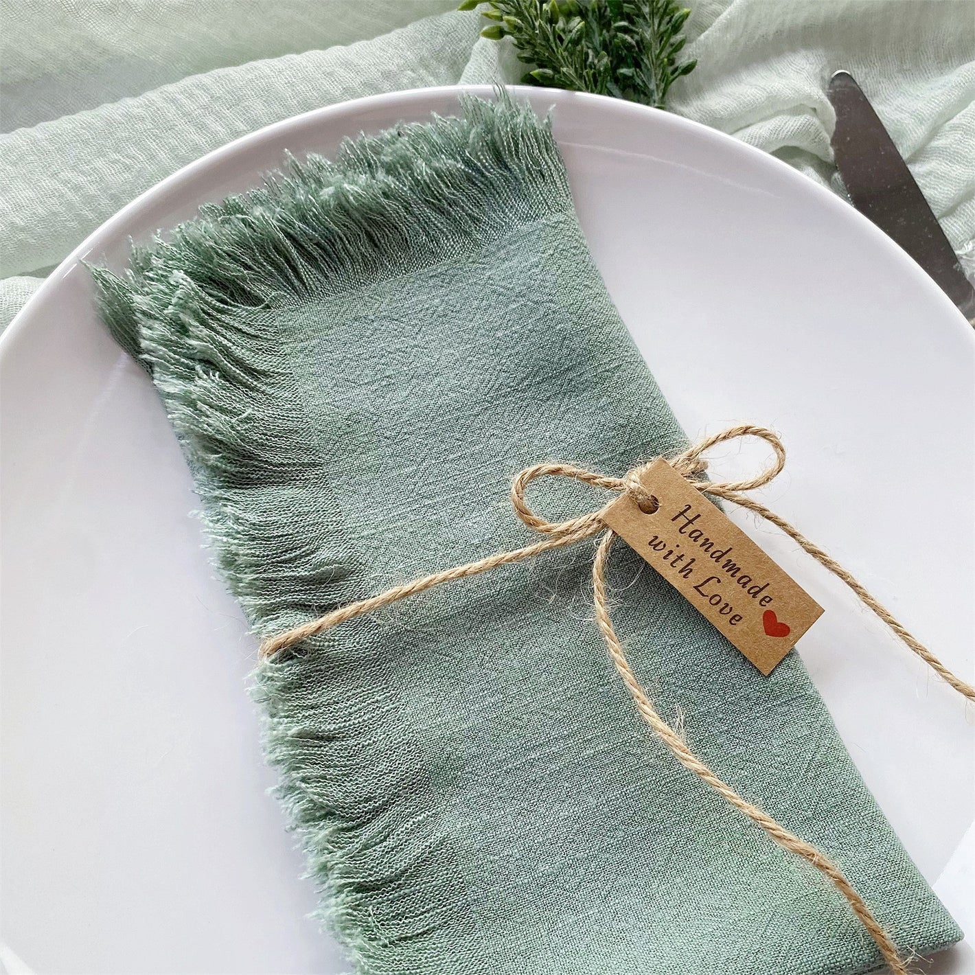 Raw edge cotton linen napkins styled across a set dining table